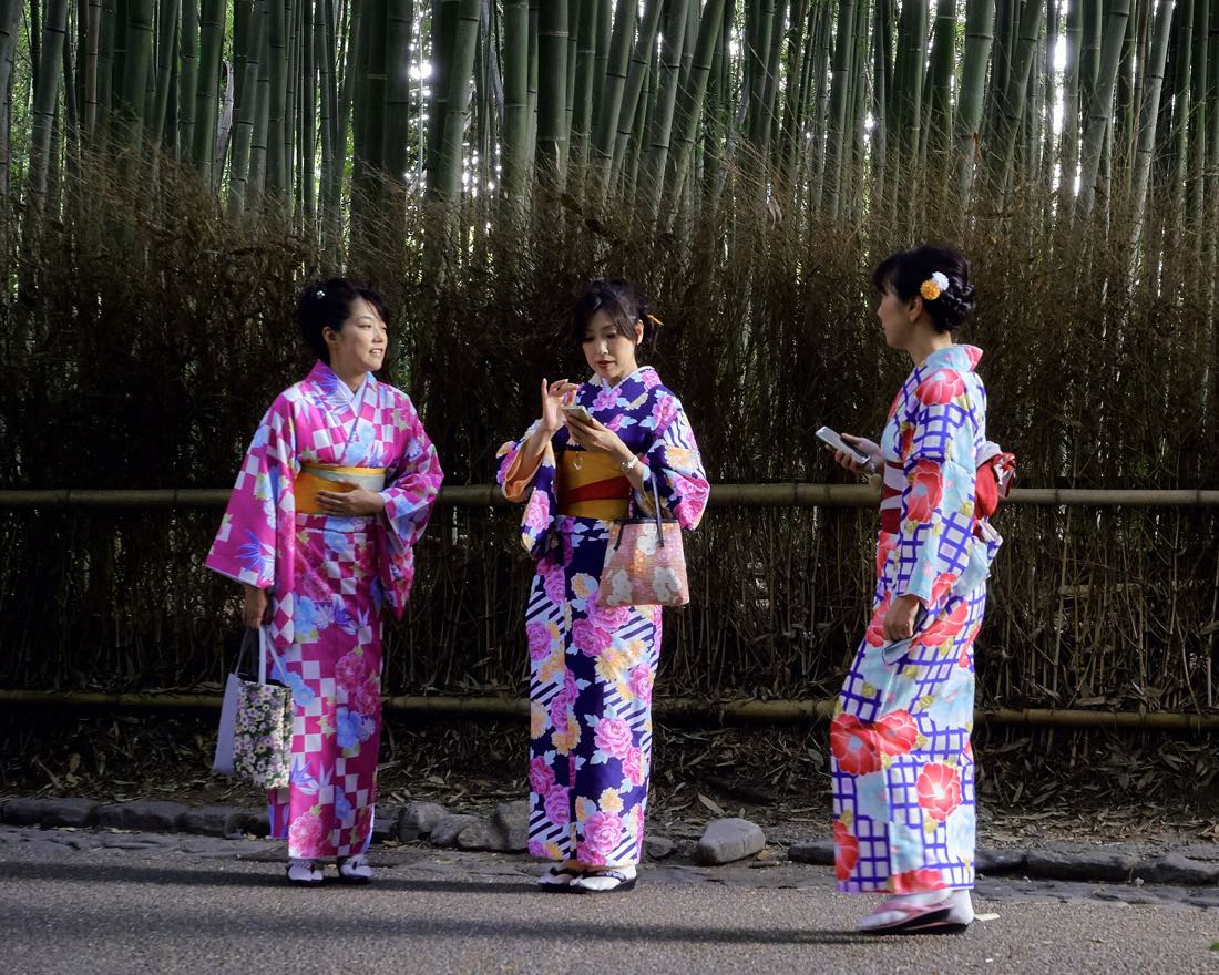 Visitors in kimono walking a street in Kyoto
