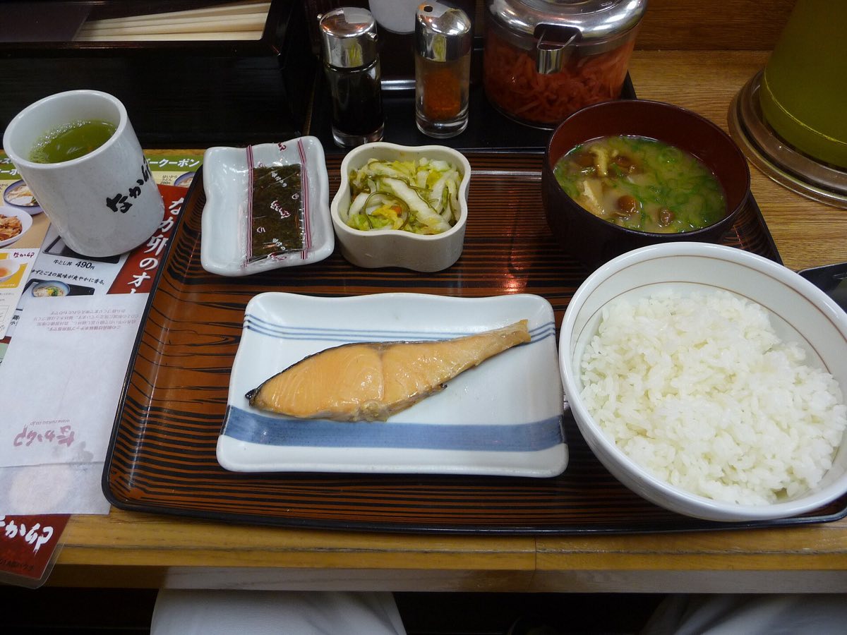 A Japanese breakfast set of grilled fish, rice and miso soup